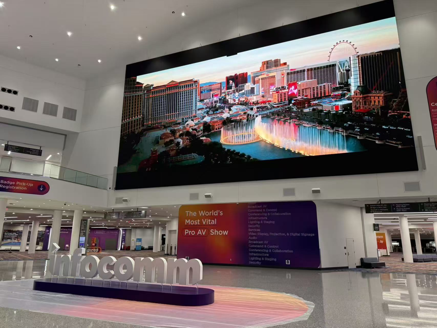 Large wide-format LED wall installed above a convention lobby