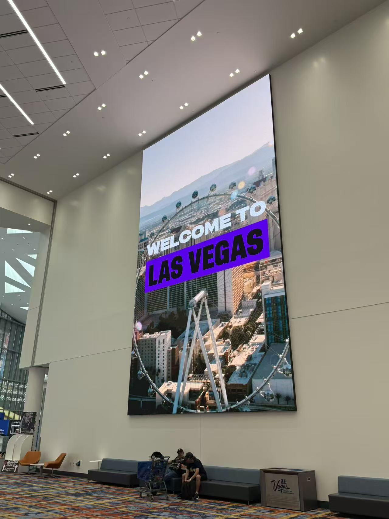 Tall portrait LED display installed on an interior lobby wall